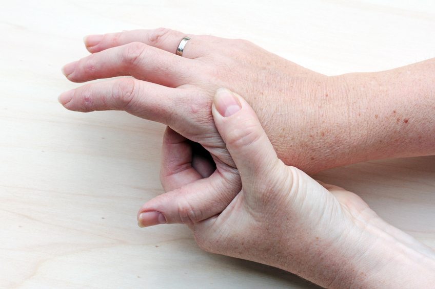 woman rubbing sore hands