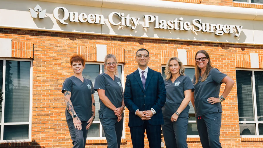 Dr. Haque and four staff members standing outside the brick clinic.
